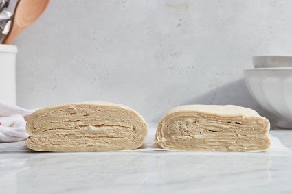 Two types of laminated dough, cut in half to reveal the cross-sections and the layers