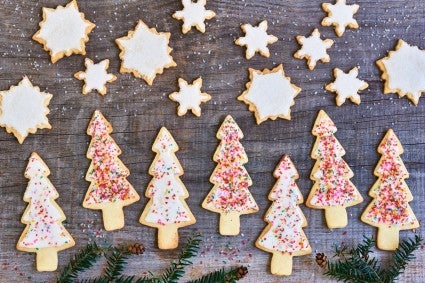 Cutout star and tree cookies, iced and decorated.