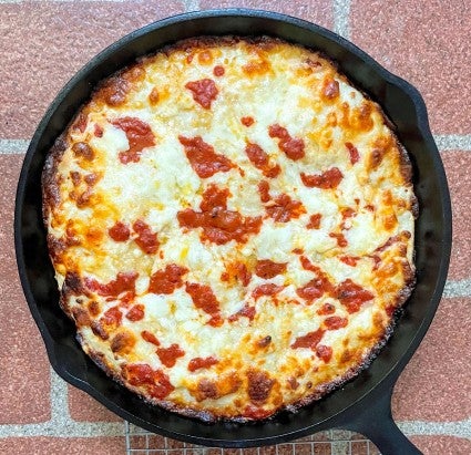 Crispy Cheesy Pan Pizza baked in a cast iron skillet.