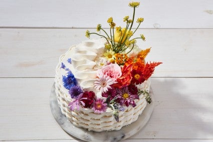 Basket weave cake decorated with a rainbow of flowers