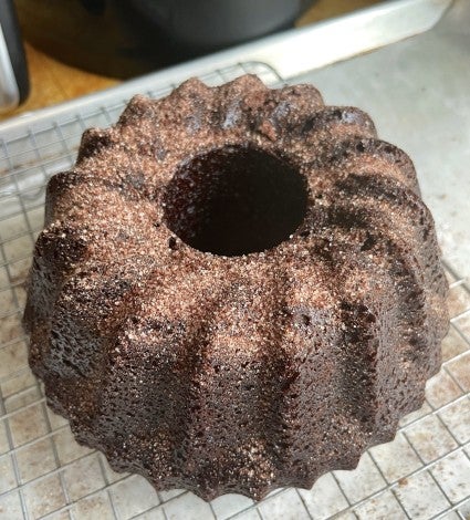 Chocolate Bundt cake on a cooling rack, warm from the air fryer.