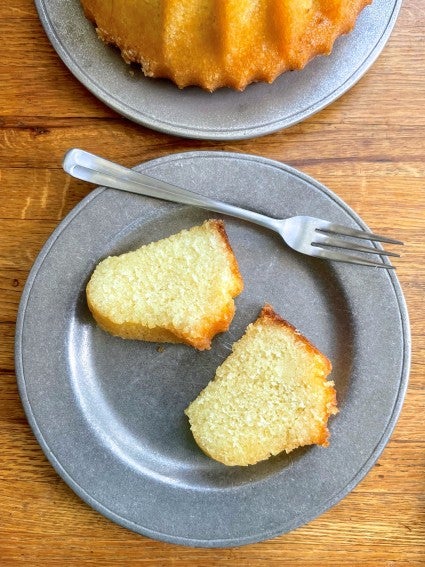 Two slices of lemon Bundt cake on a plate.  