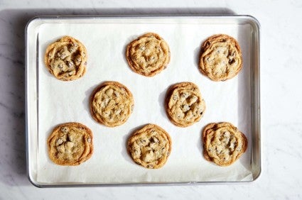 Chocolate chip cookies baked on a parchment-lined baking sheet
