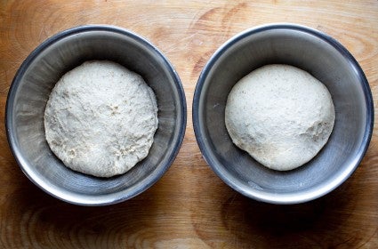 Two doughs in bowls, rising