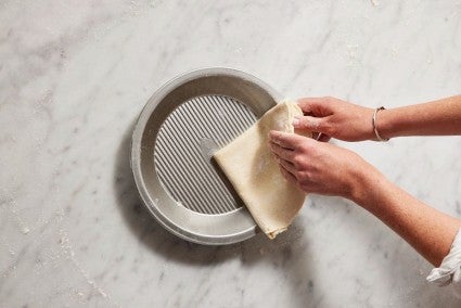 Rolled-out pie dough folded in qaurters