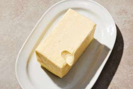 Softened butter with indent from a finger