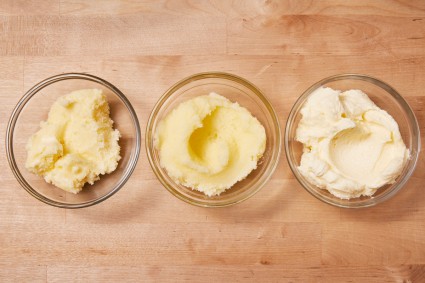 A bowl of cold butter creamed with sugar, a bowl of half-melted butter creamed with sugar, and a bowl of room temperature butter creamed with sugar