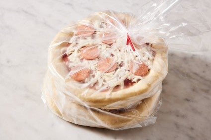 Frozen pizzas in a plastic, freezer-safe bag