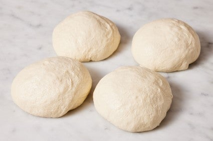 Four balls of pizza dough