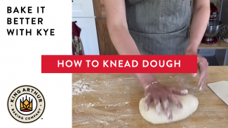 Hands kneading dough on a counter