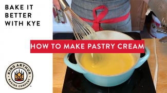 Hands whisking a saucepan of pastry cream on the stovetop 